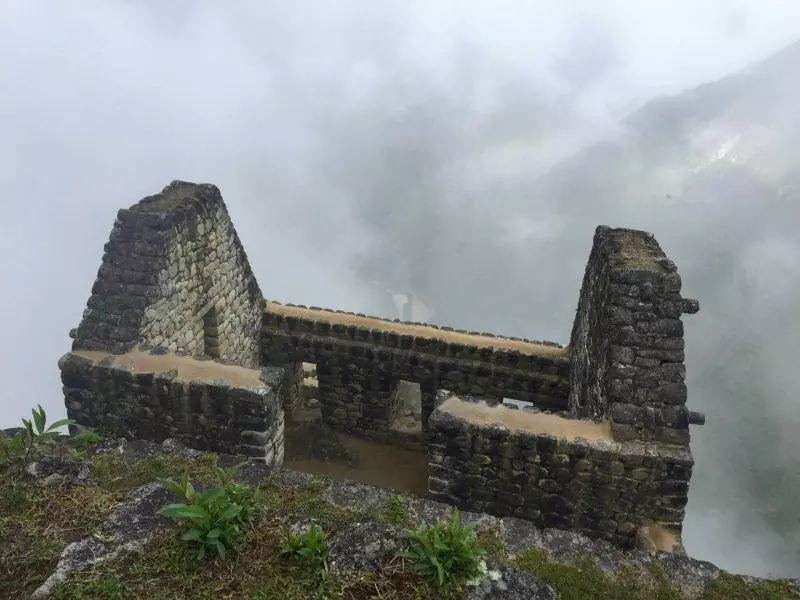 Structure at Huayna Picchu surrounded by clouds