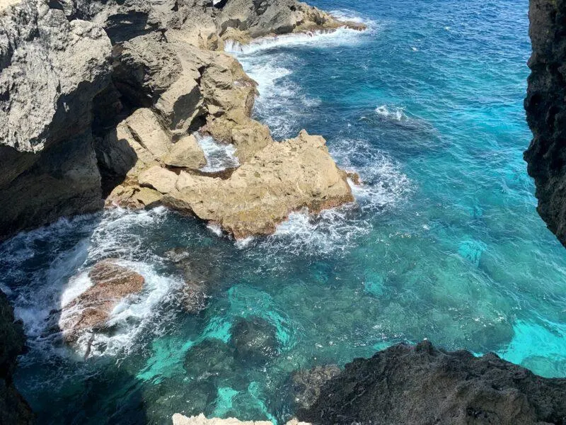 Blue water and rock cliffs from above