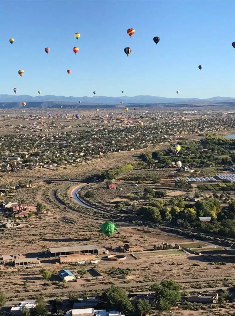 The Albuquerque International Balloon Fiesta is a bucket list item. Find out how you can book a ticket to go on a hot air balloon ride during mass ascension, with hundreds of other balloons. New Mexico is the perfect place for a hot air balloon ride. Don't go to the balloon festival without reading this post. Save to your travel board for inspiration.
