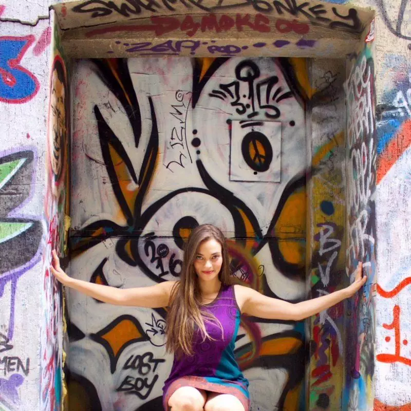 Woman taking a photo in Graffiti Alley nook