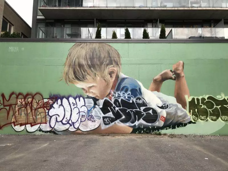 Toddler on a green wall