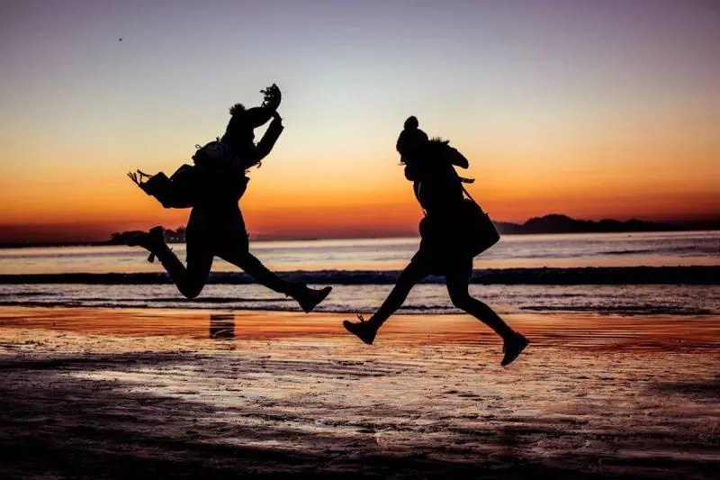 Women jumping at the beach