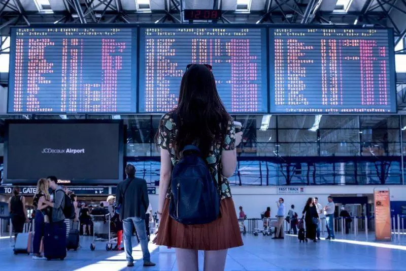 Woman looking at airport screen