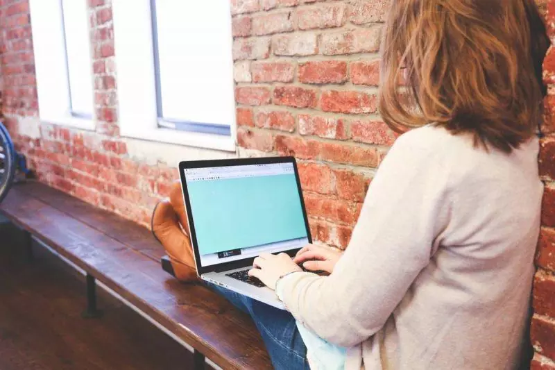 Woman typing on her laptop