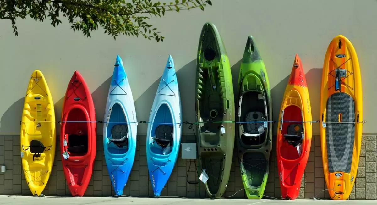 Colorful kayaks up against a wall