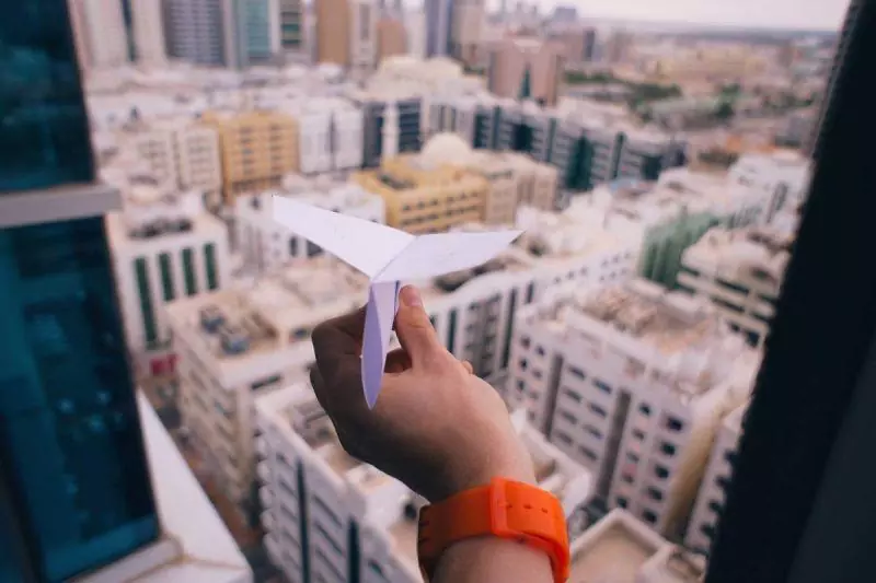 Paper airplane over buildings