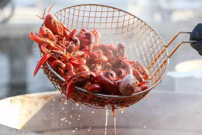 Crawfish being scooped out of boiling water