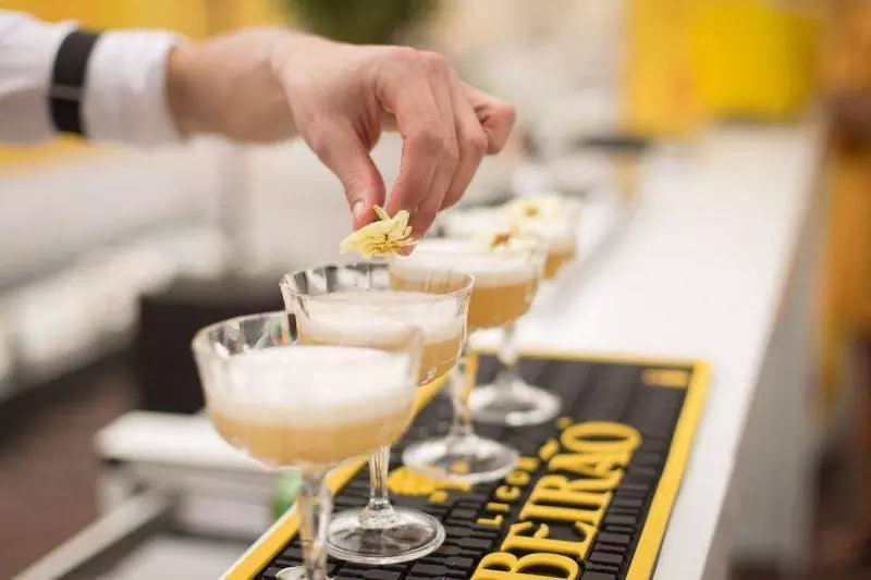 Cocktails lined up at a bar