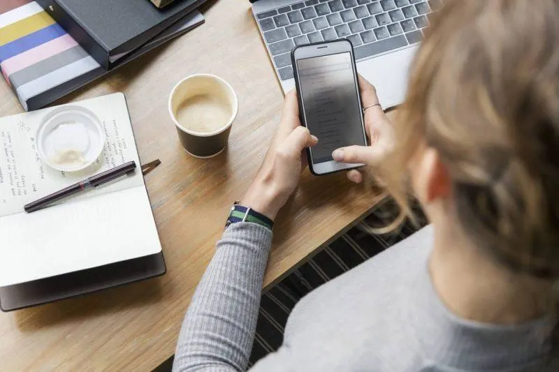 Woman checking her email on her phone