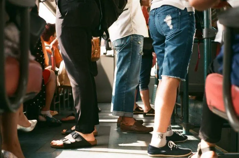 Feet of people standing on public transport 