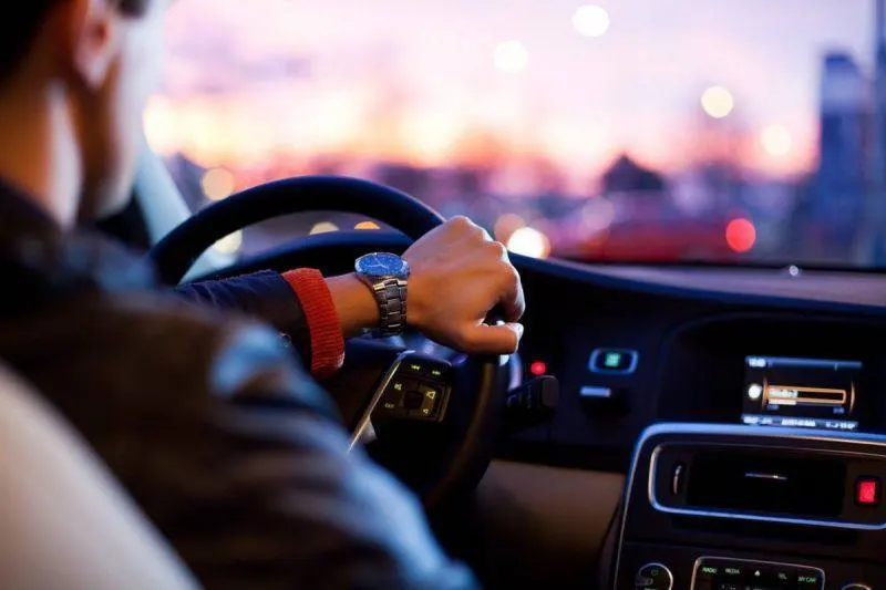 Man driving a fancy car