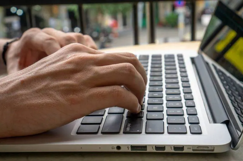 Man typing on a computer