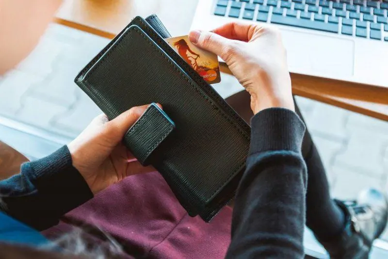 Woman pulling credit card out of wallet