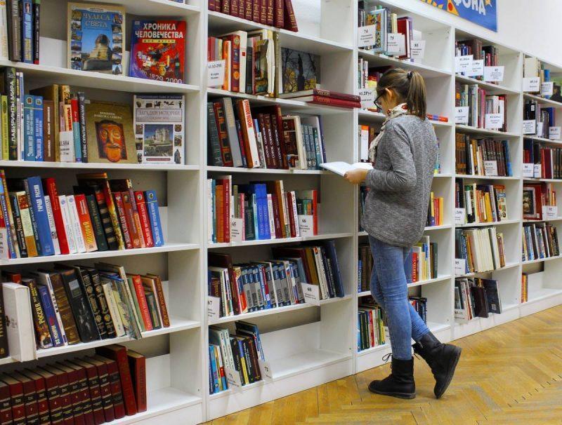 Woman reading a book at the library