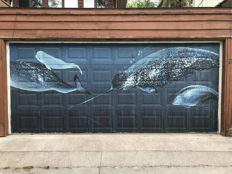 Whales swimming in the ocean painted on garage door