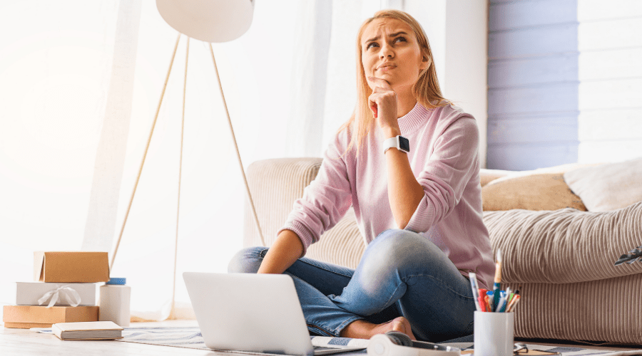 Woman contemplating while at laptop