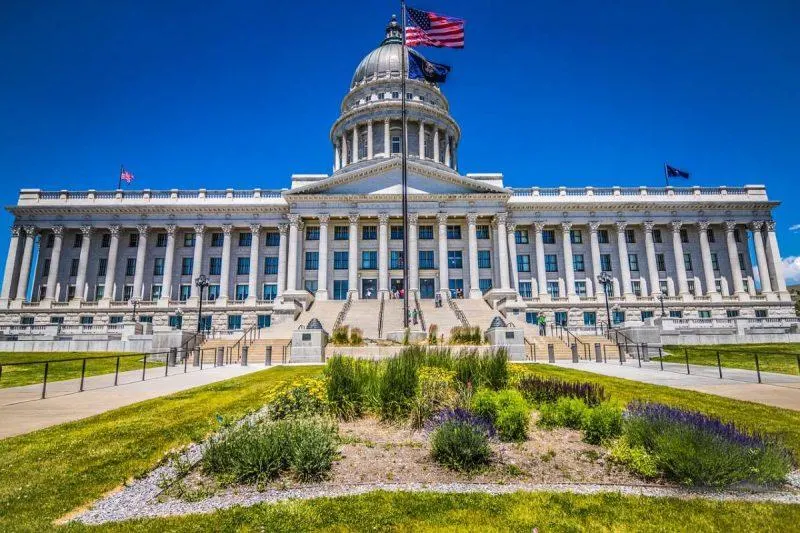 Capital building with American flag waving out front