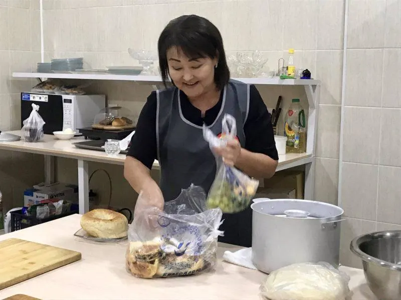 Happy woman pulling ingredients out of a bag