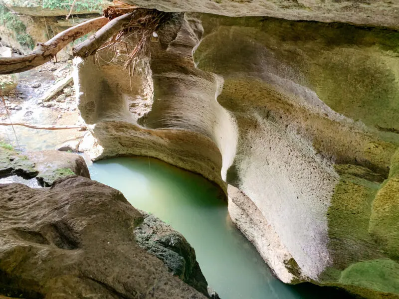 Blue water bond surrounded by swirling rock walls