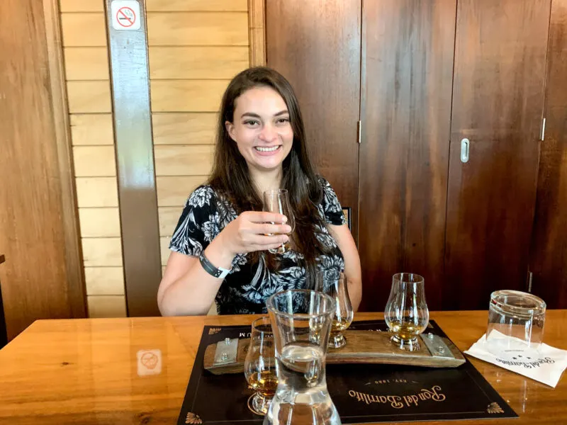 Woman holding sipping glass of rum