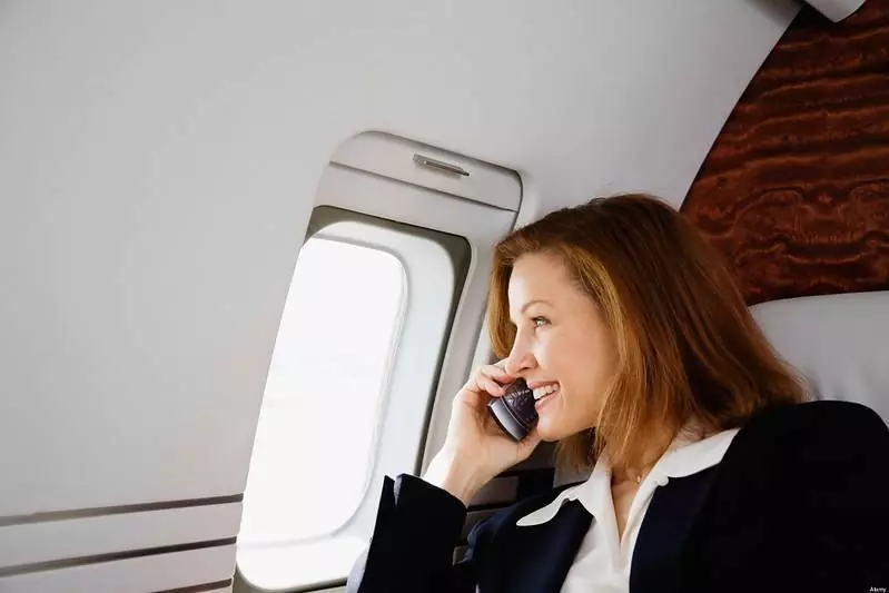 Woman talking on her phone on an airplane