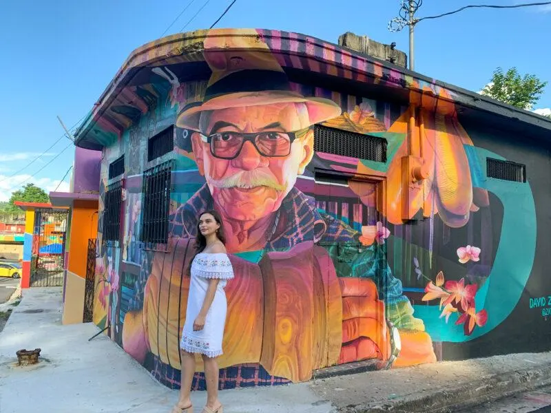 Woman standing in front of mural