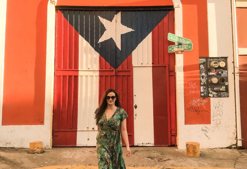 Walking in front of a mural of the Puerto Rican flag