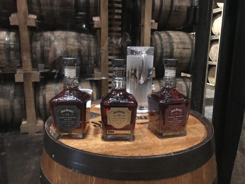 Whiskey bottles on a barrel