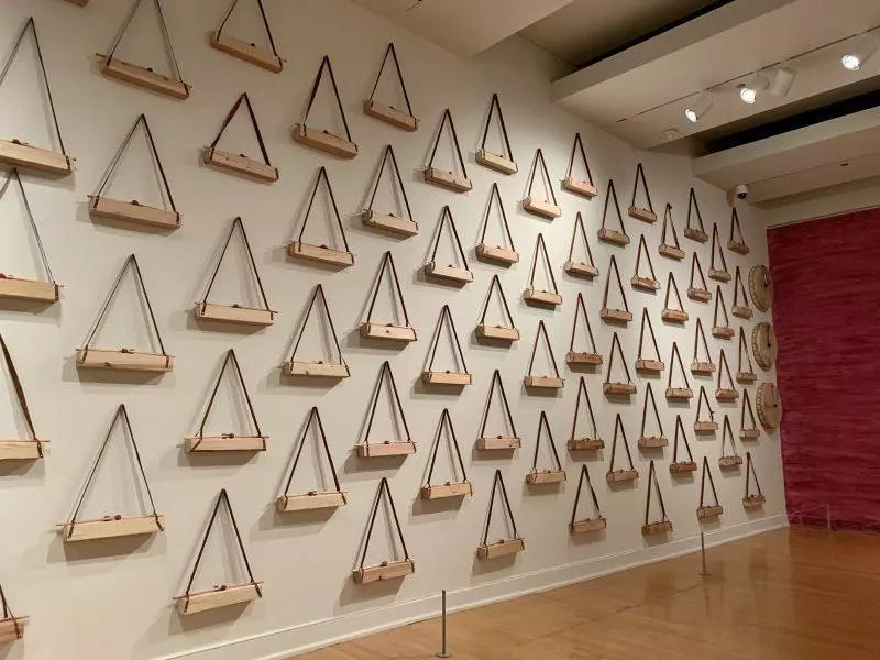 Wall of triangle objects hanging at a museum