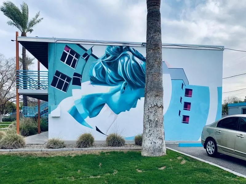 blue street art mural of a woman