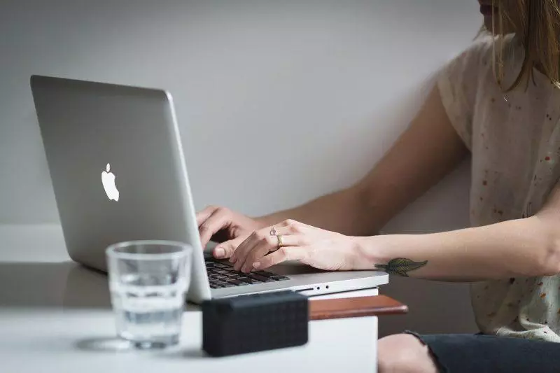 Woman typing on laptop