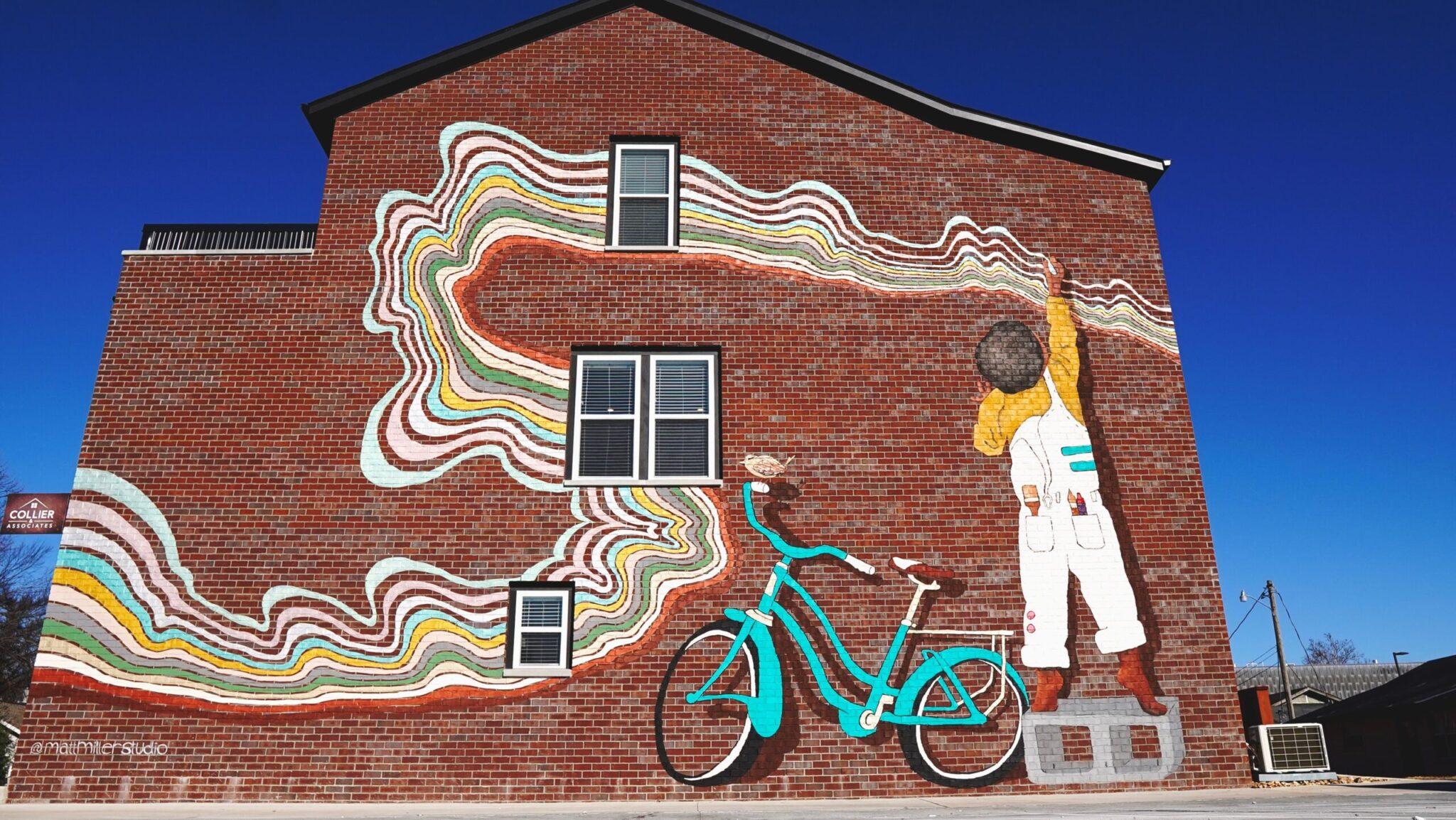 Colorful mural of boy and bike