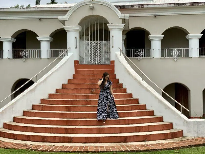 Woman coming down hacienda steps