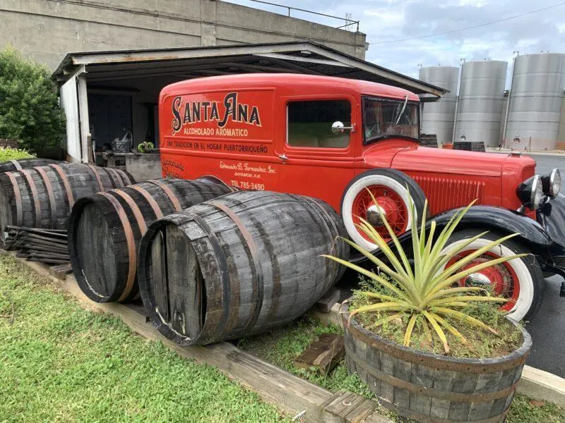 Red vintage truck with rum barrels in front