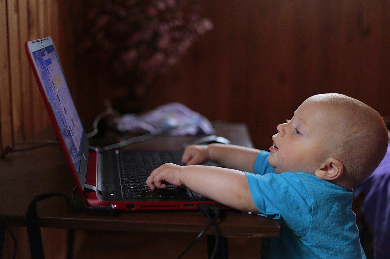 Baby playing on computer