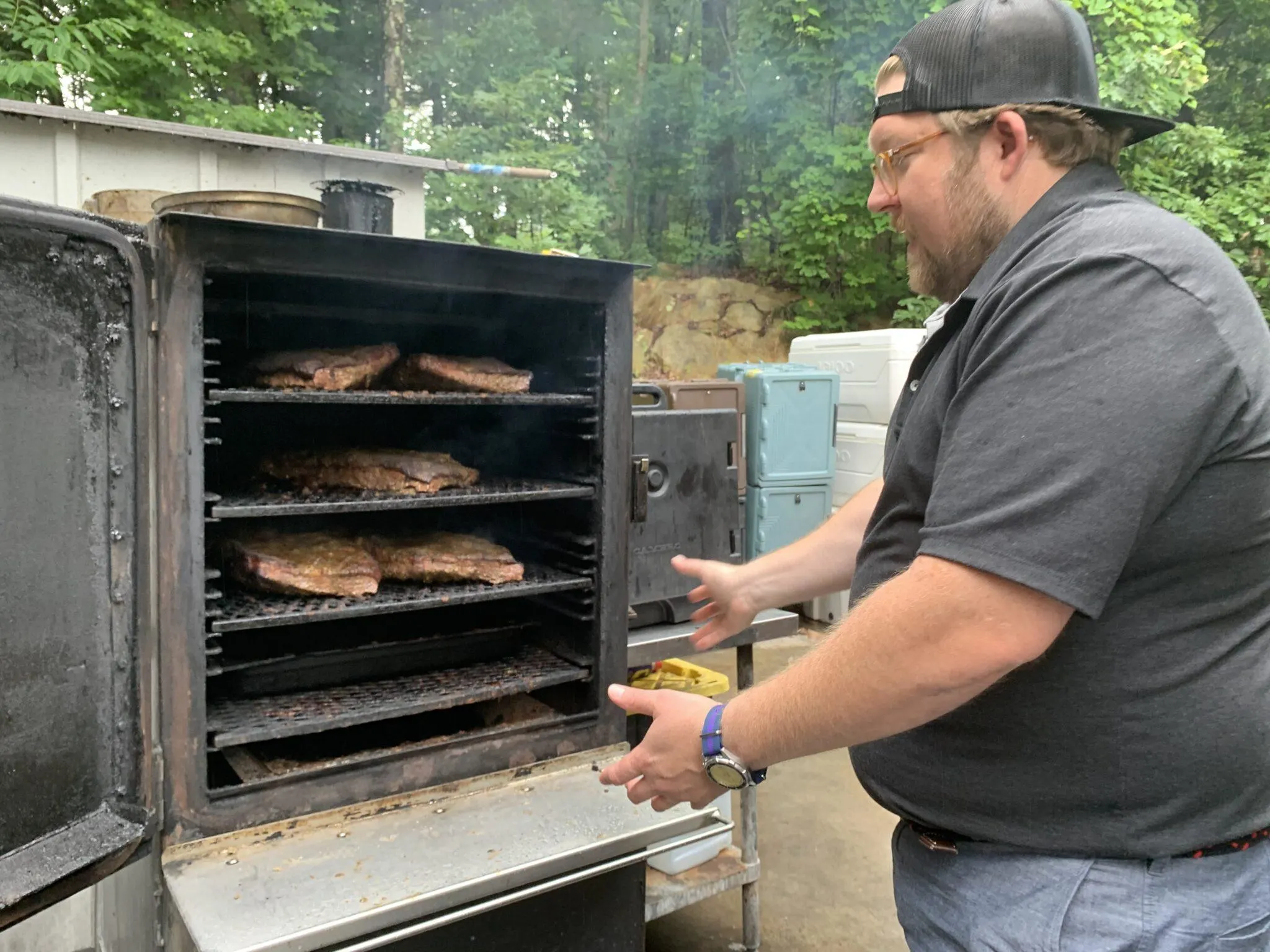 Man in front of meat roaster