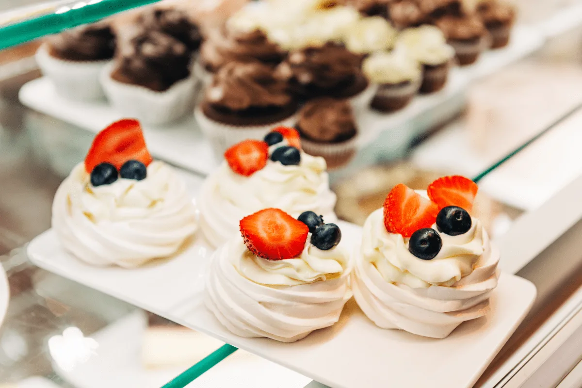 Cupcakes with white frosting and berries on top