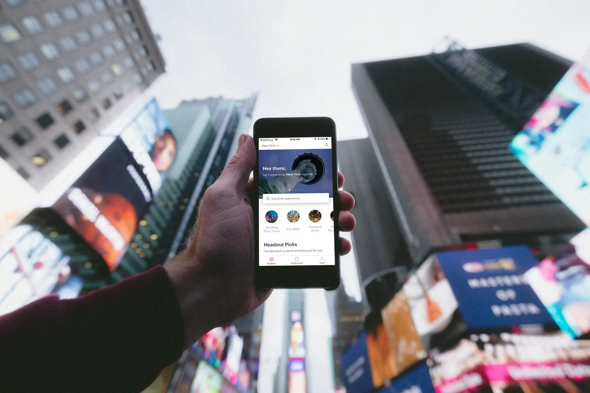 Mobile phone facing sky in Times Square