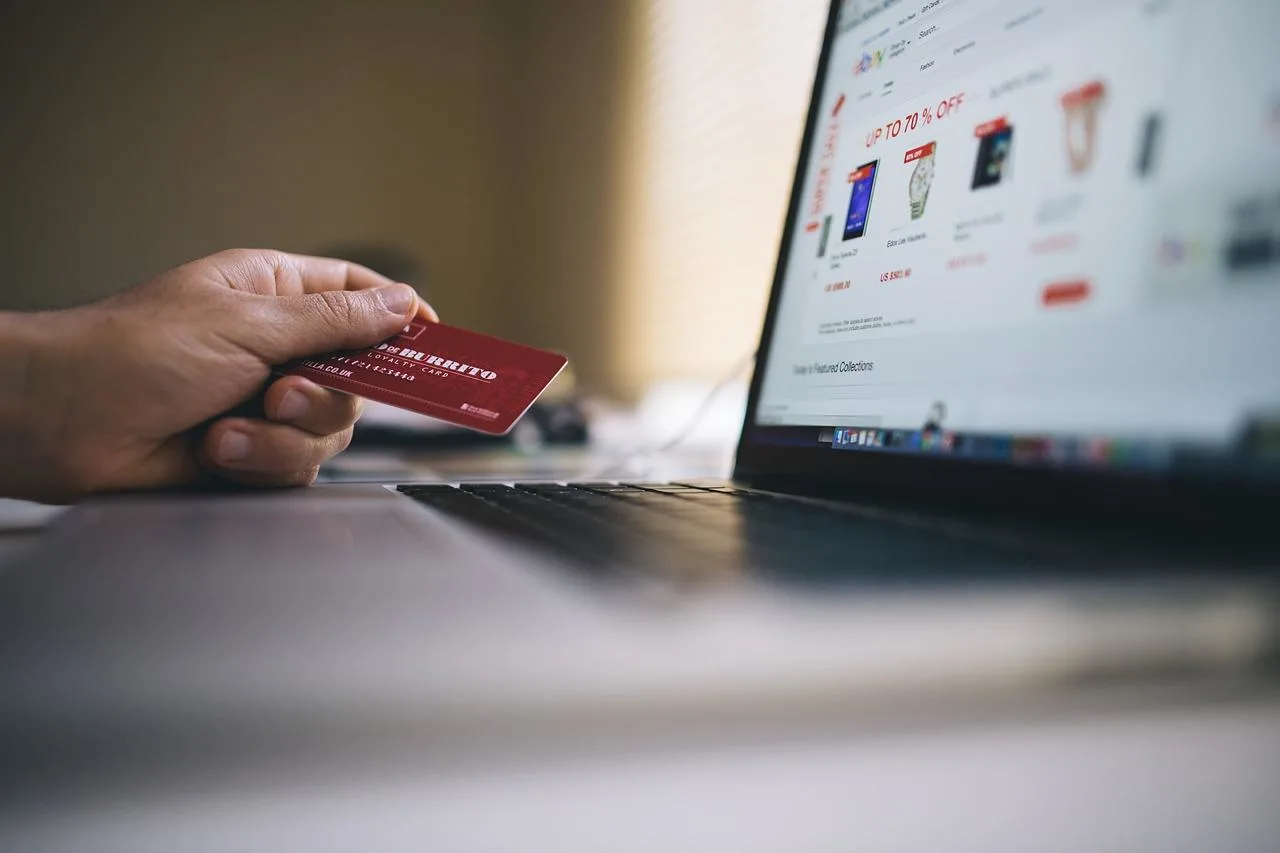 Man online shopping with credit card in hand