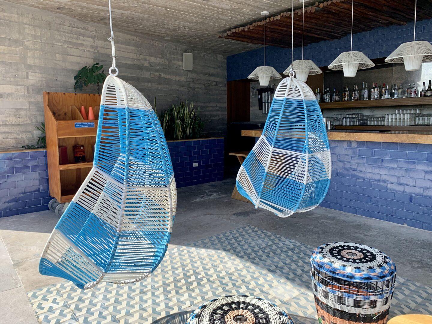Hanging blue and white chairs at beach bar