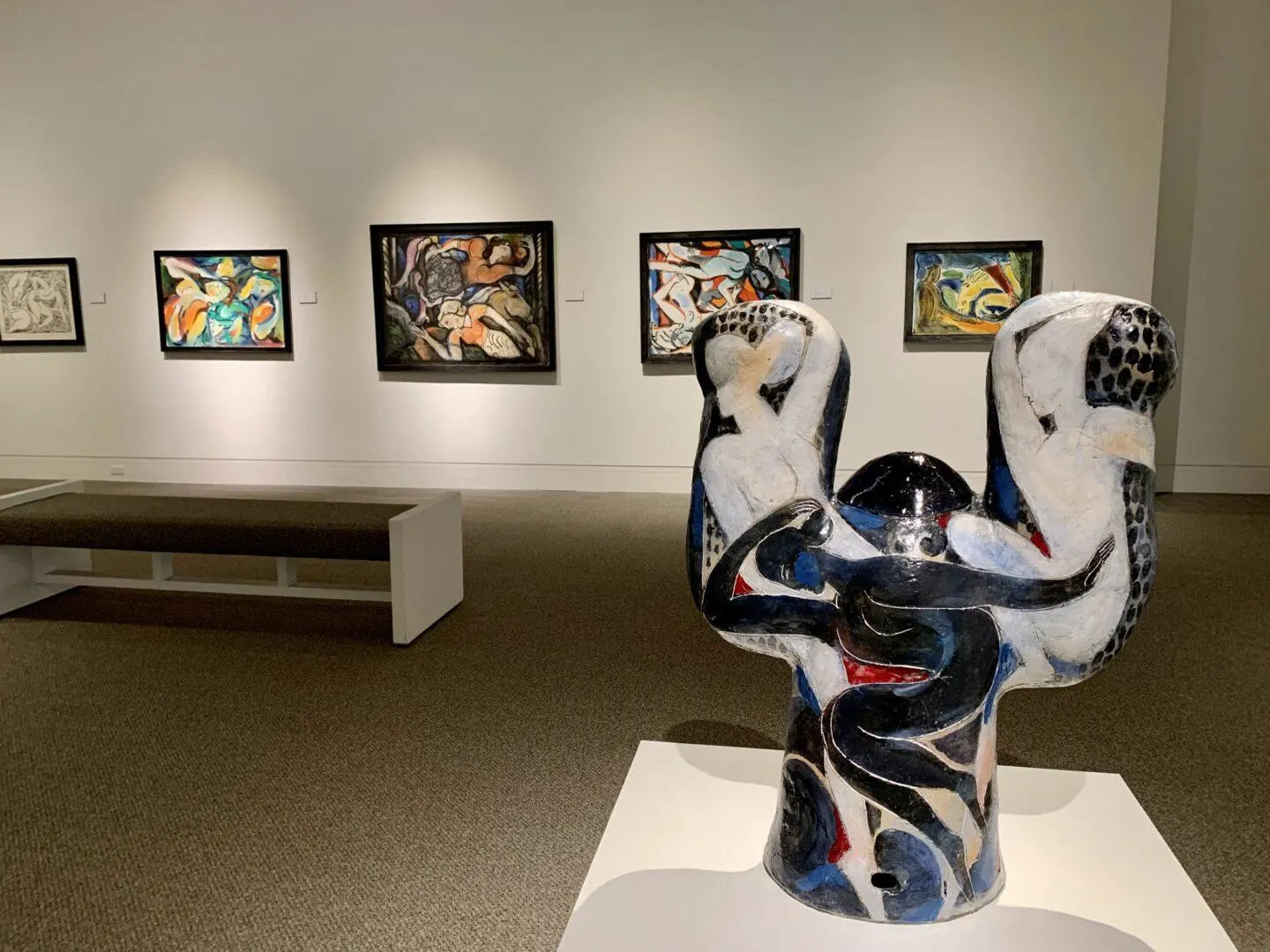 Sculpture and paintings in an indoor art gallery