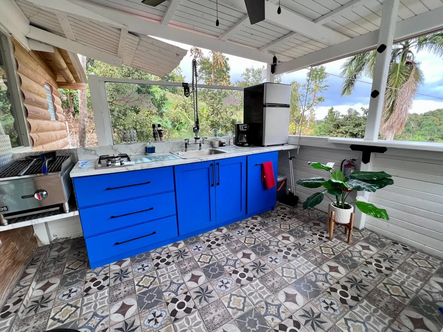 Outdoor kitchen with bright blue cabinets