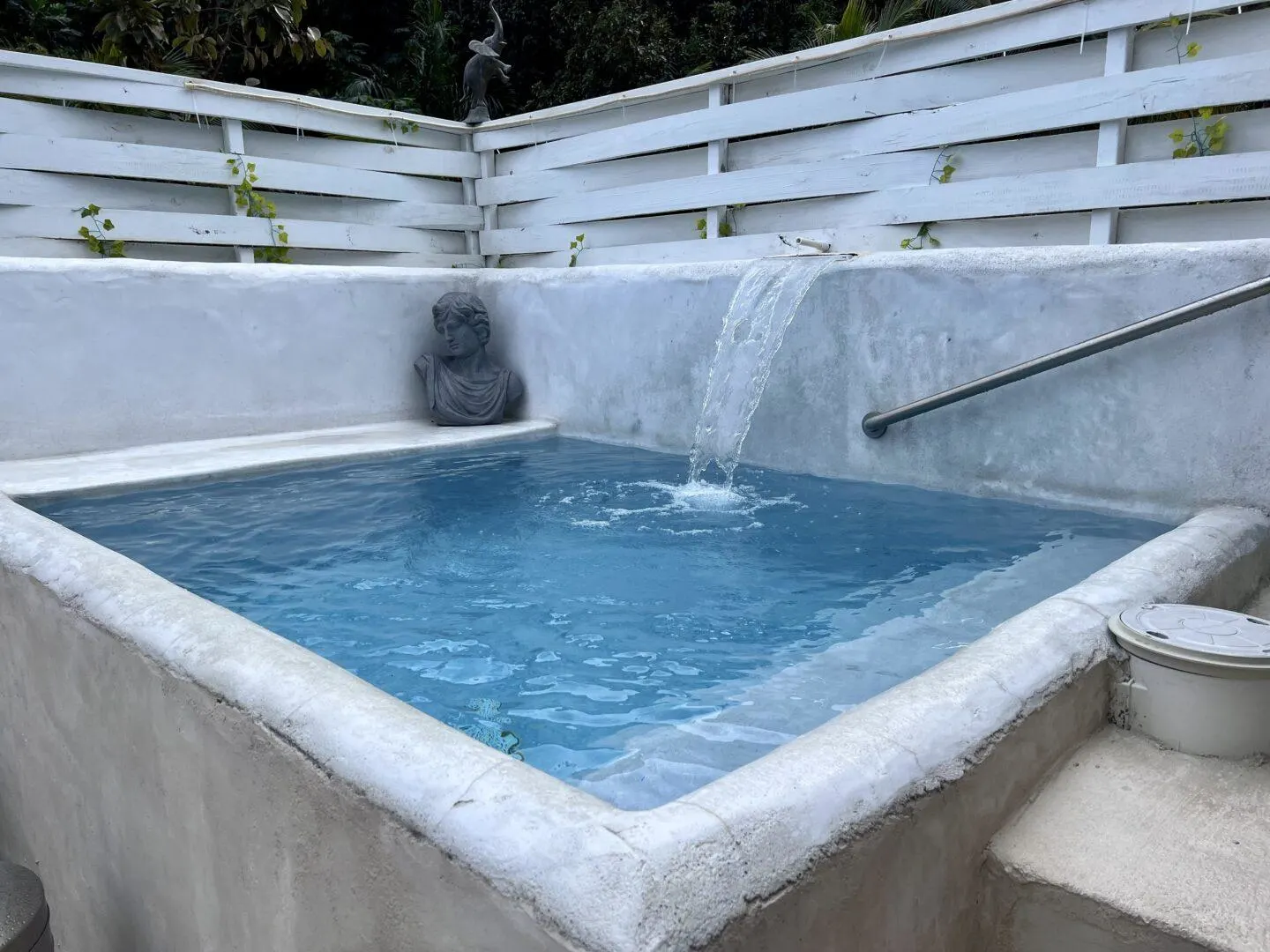 Pool with bust and running water