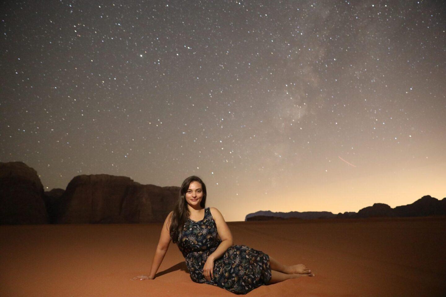 Woman in the desert under the night sky