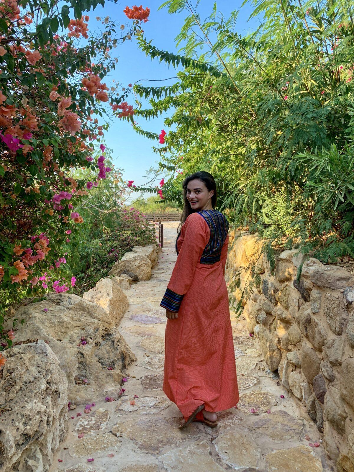Woman in garden looking back over shoulder