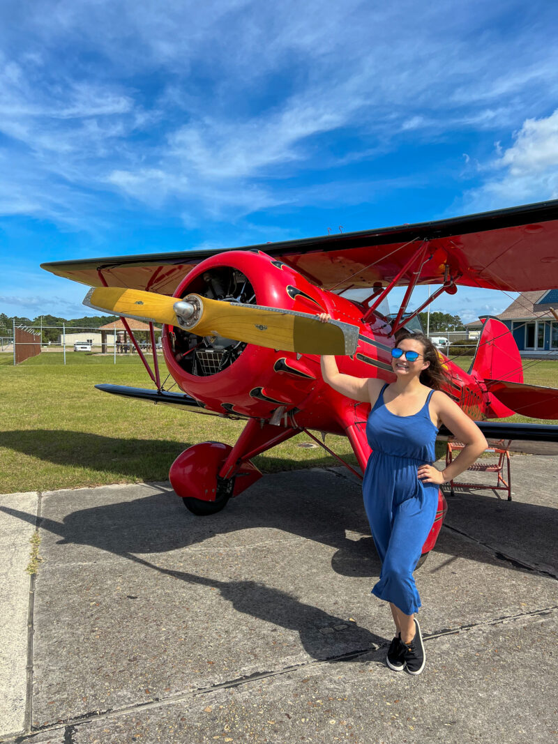 Woman standing next to biplane with Shady Rays sunglasses on