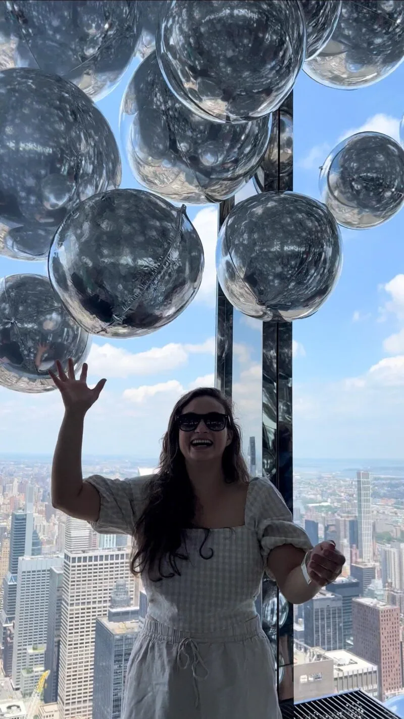 Woman playing with silver balloons