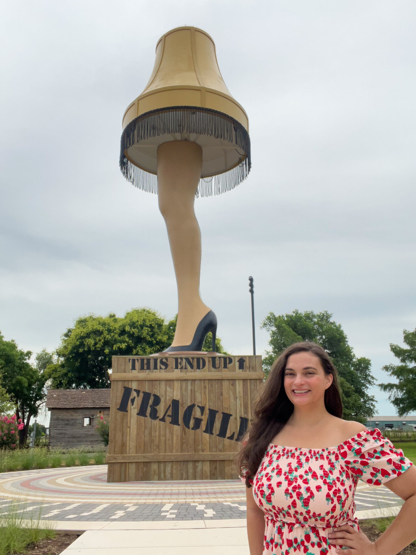Woman standing in front of giant leg lamp