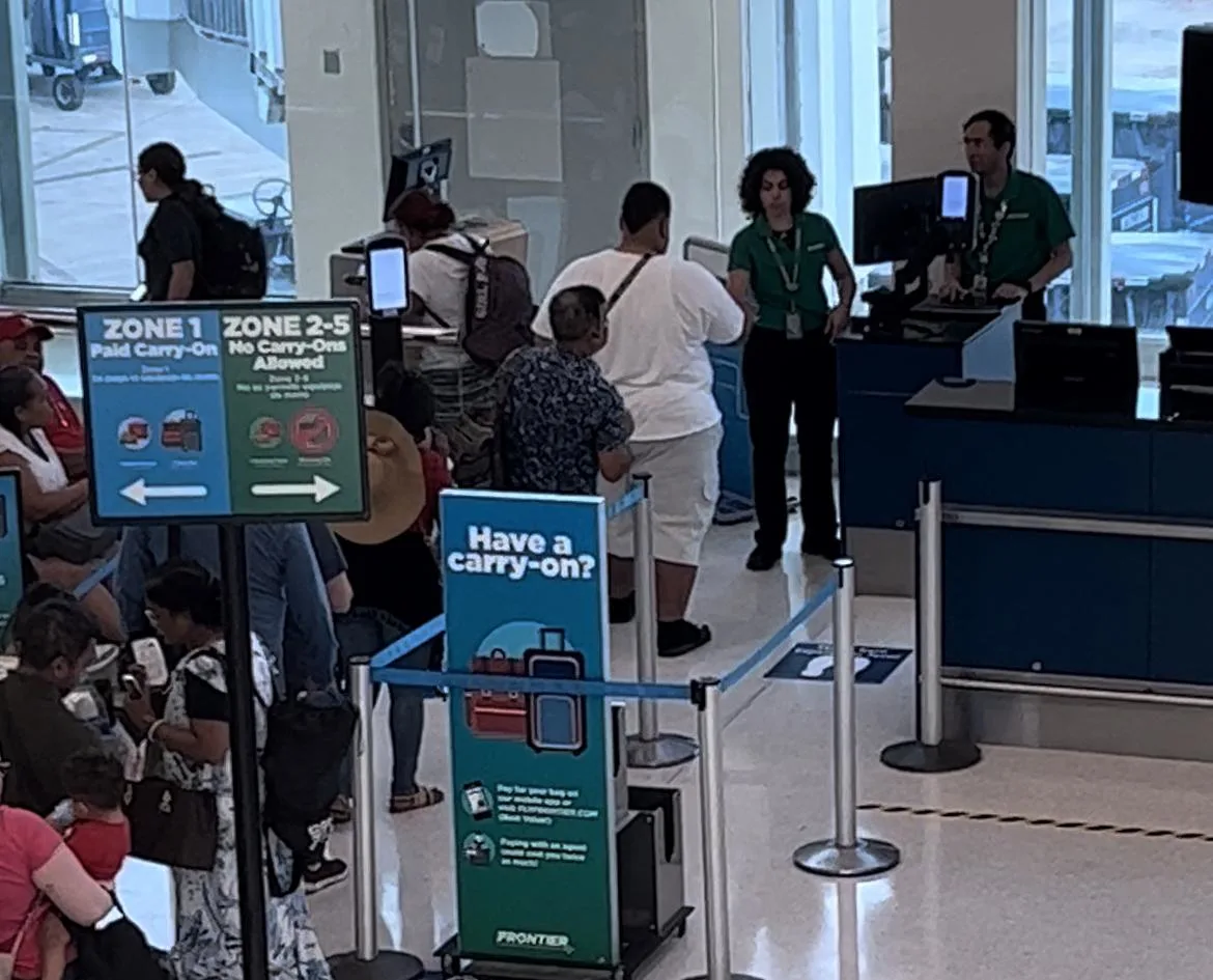 People in line to board Frontier Airlines plane