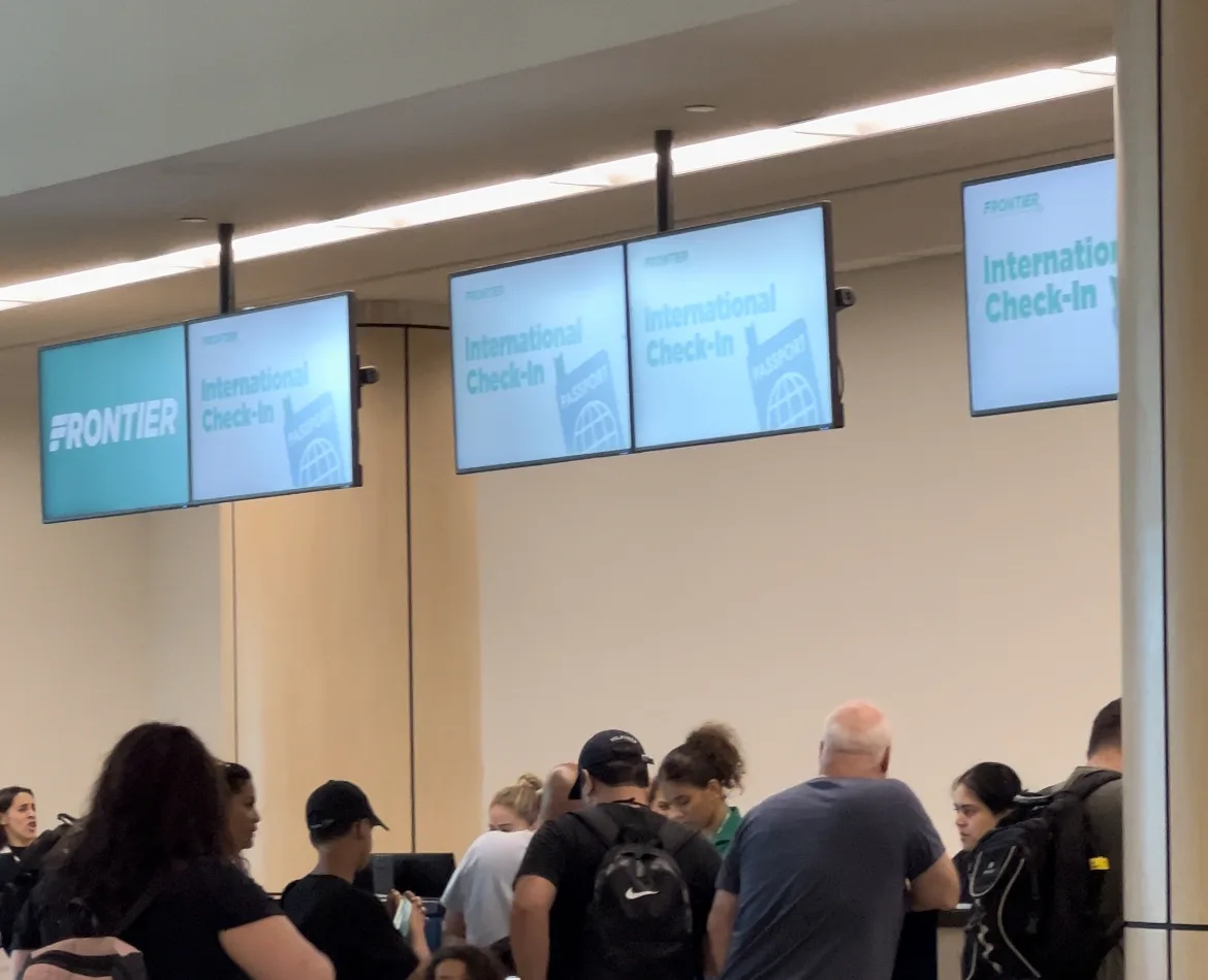 People lined up for Frontier Airlines check in at airport